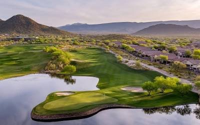 Aerial view of a water hole and peninsula green inside the Anthem Country Club gates